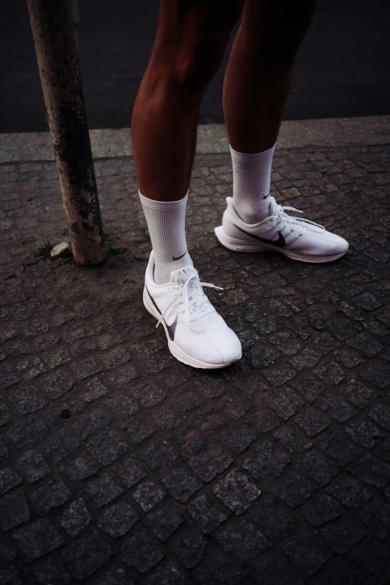 person wearing white Nike shoes
