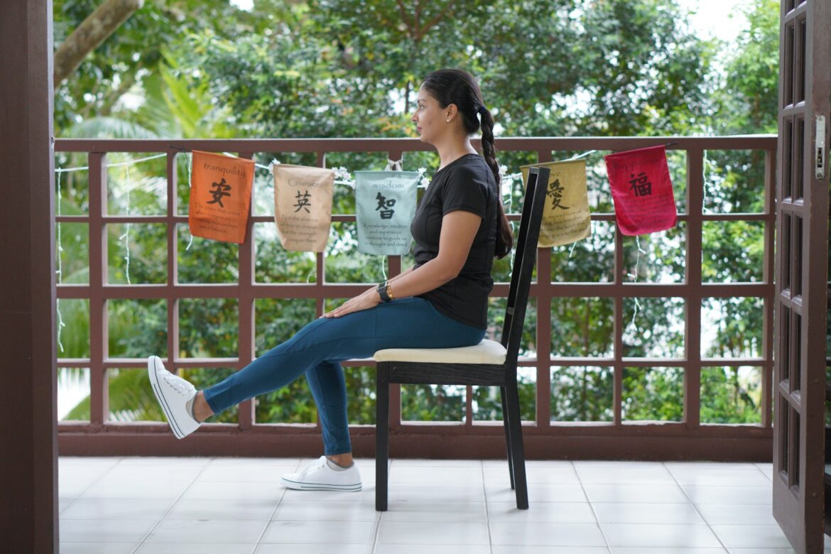 a person sitting on a chair holding a bucket of popcorn