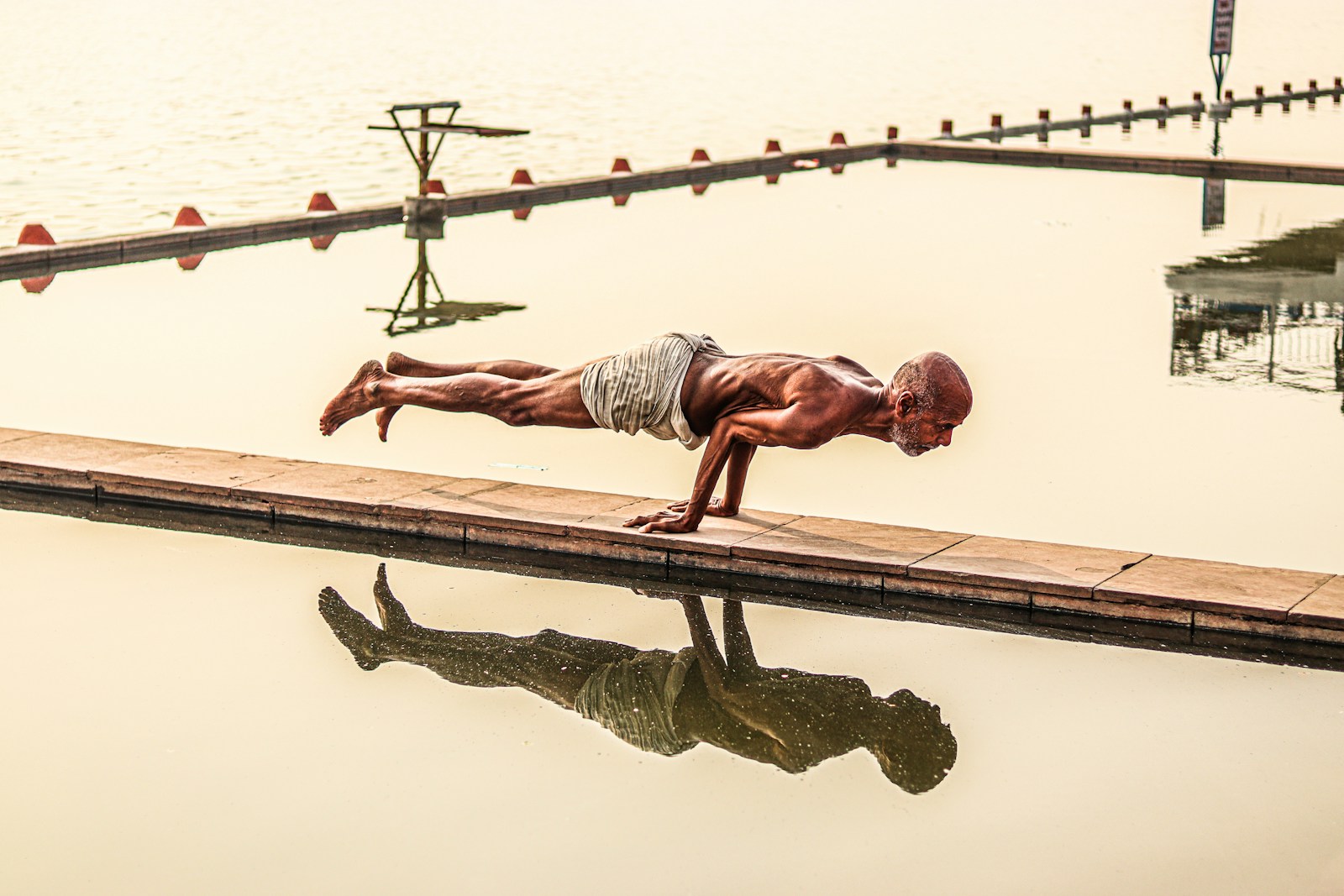 a man standing next to a body of water