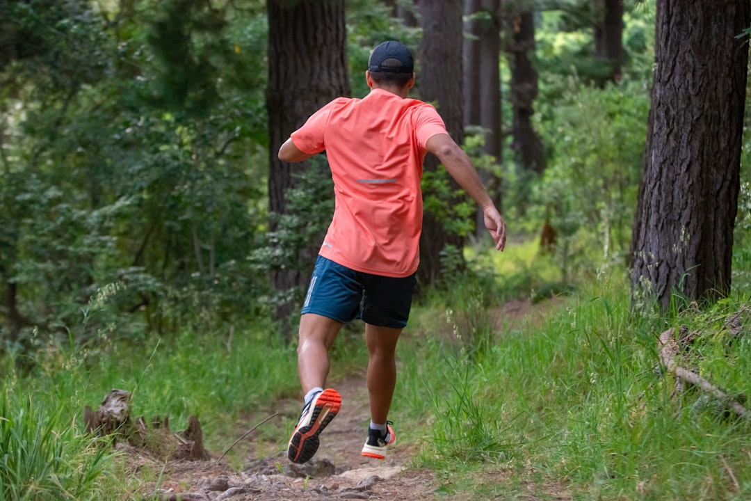 Trail runner running down a trail.