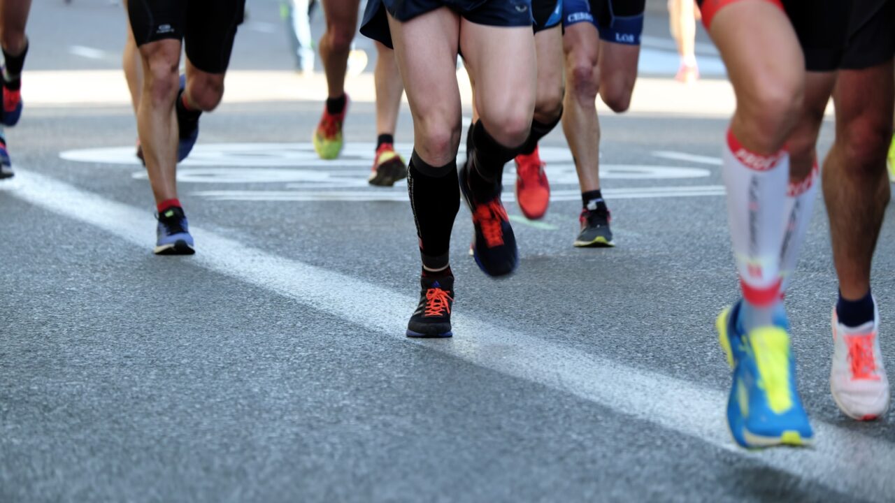 Groep hardlopers vlak na de start van een marathon in de stad
