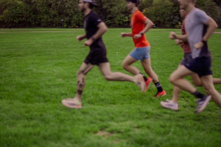 Lopers op een groen parcours door een park tijdens een marathon