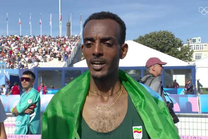 Tamirat Tola met de Ethiopische vlag na zijn olympische marathonzege in Parijs